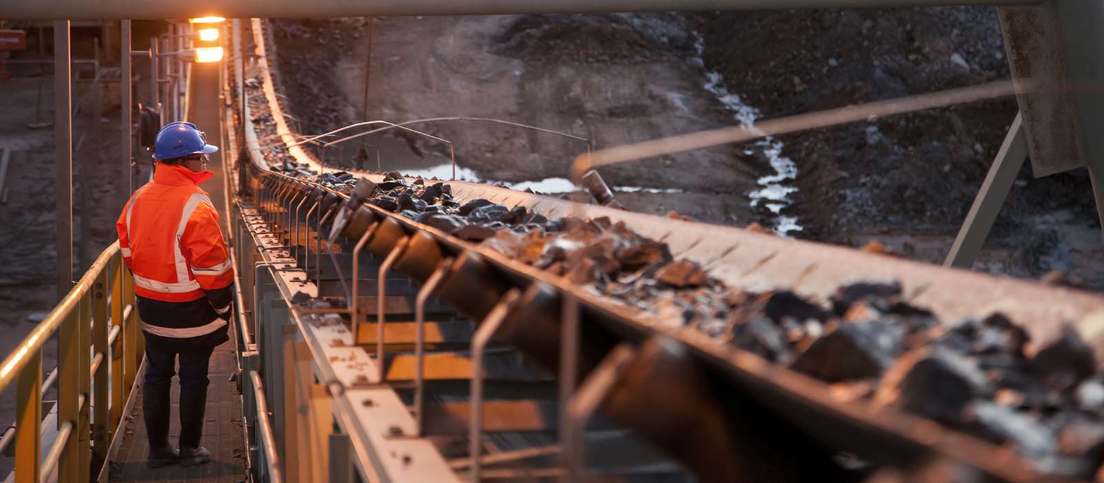 Miner next to conveyor belt
