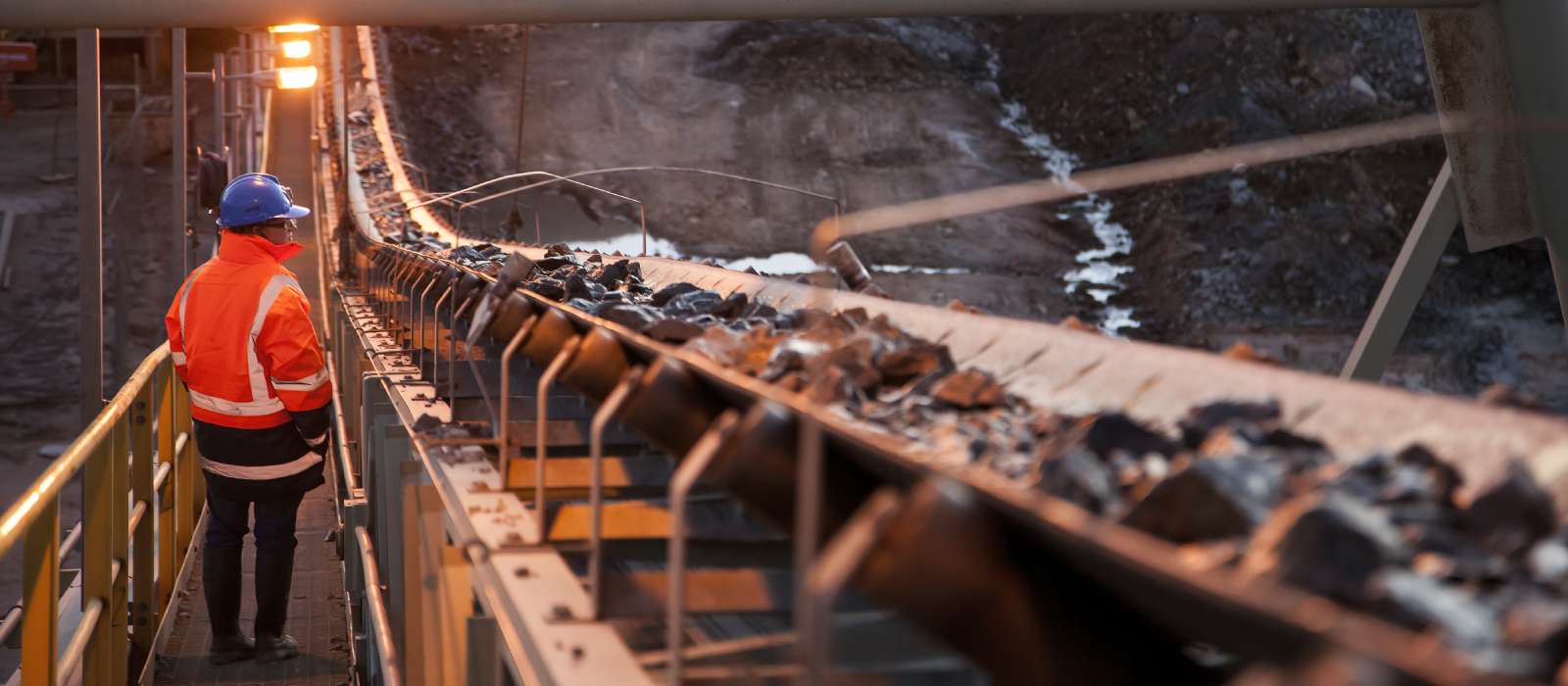Miner next to conveyor belt Miner next to conveyor belt
