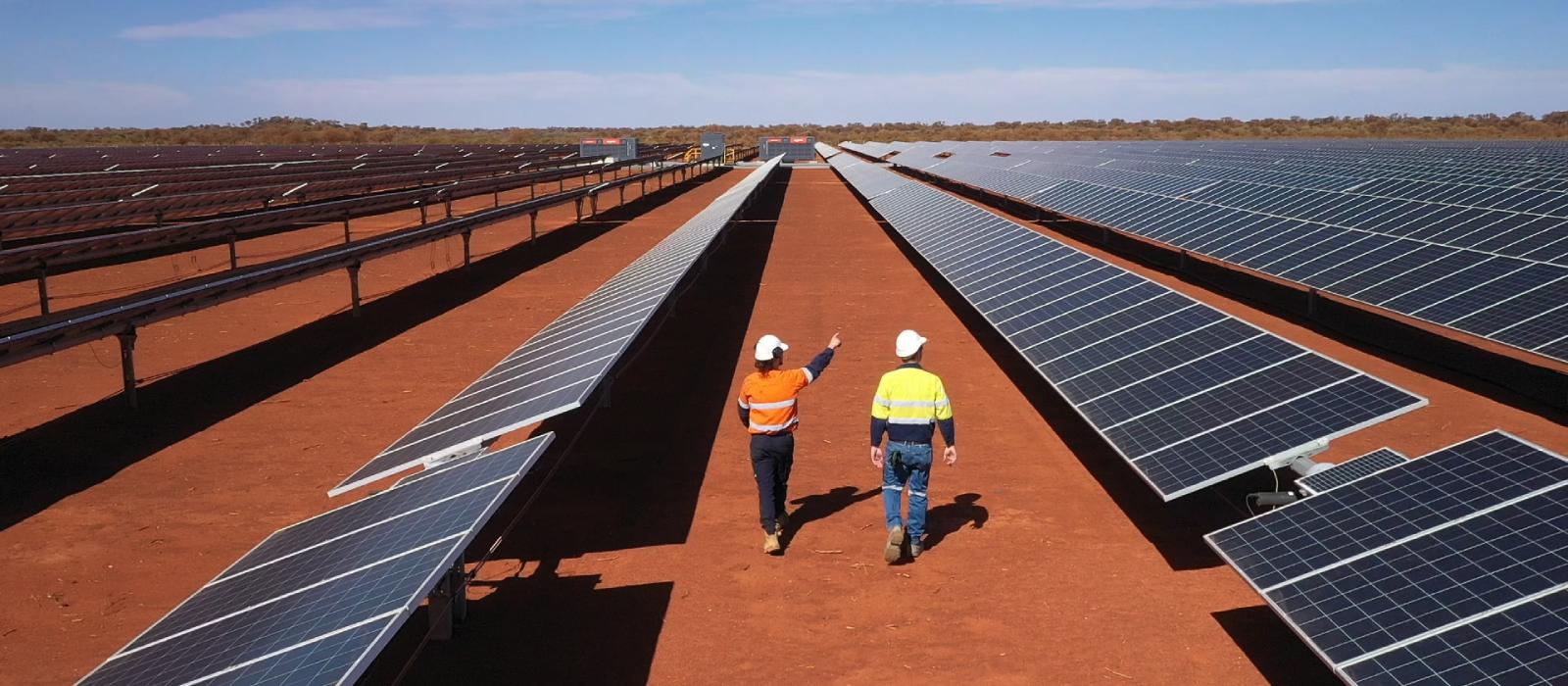 mine workers inspecting solar panels