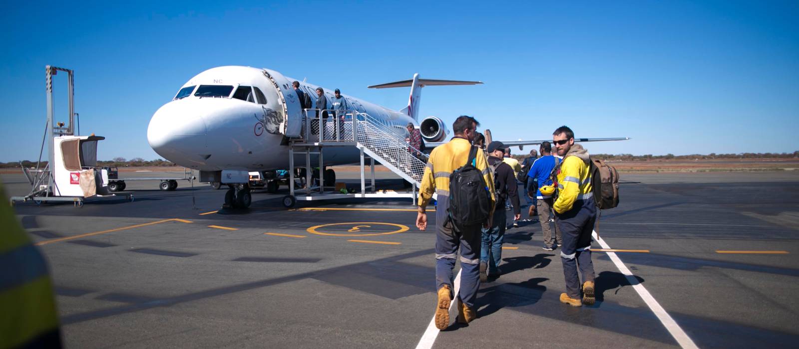 Miners boarding a plane for FIFO work Miners boarding a plane for FIFO work